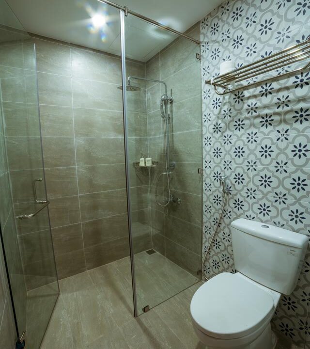 A bathroom in Danang, Vietnam with tiled walls.