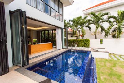 A house in Danang, Vietnam with a swimming pool in front of it.