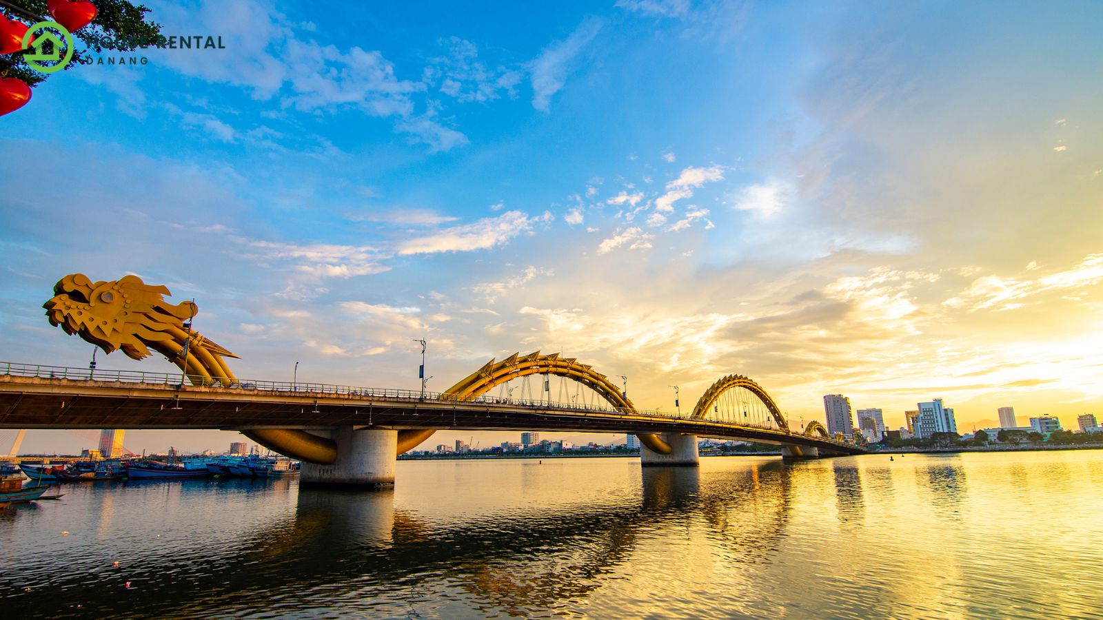 A bridge over a body of water at sunset, connecting Danang and Singapore.