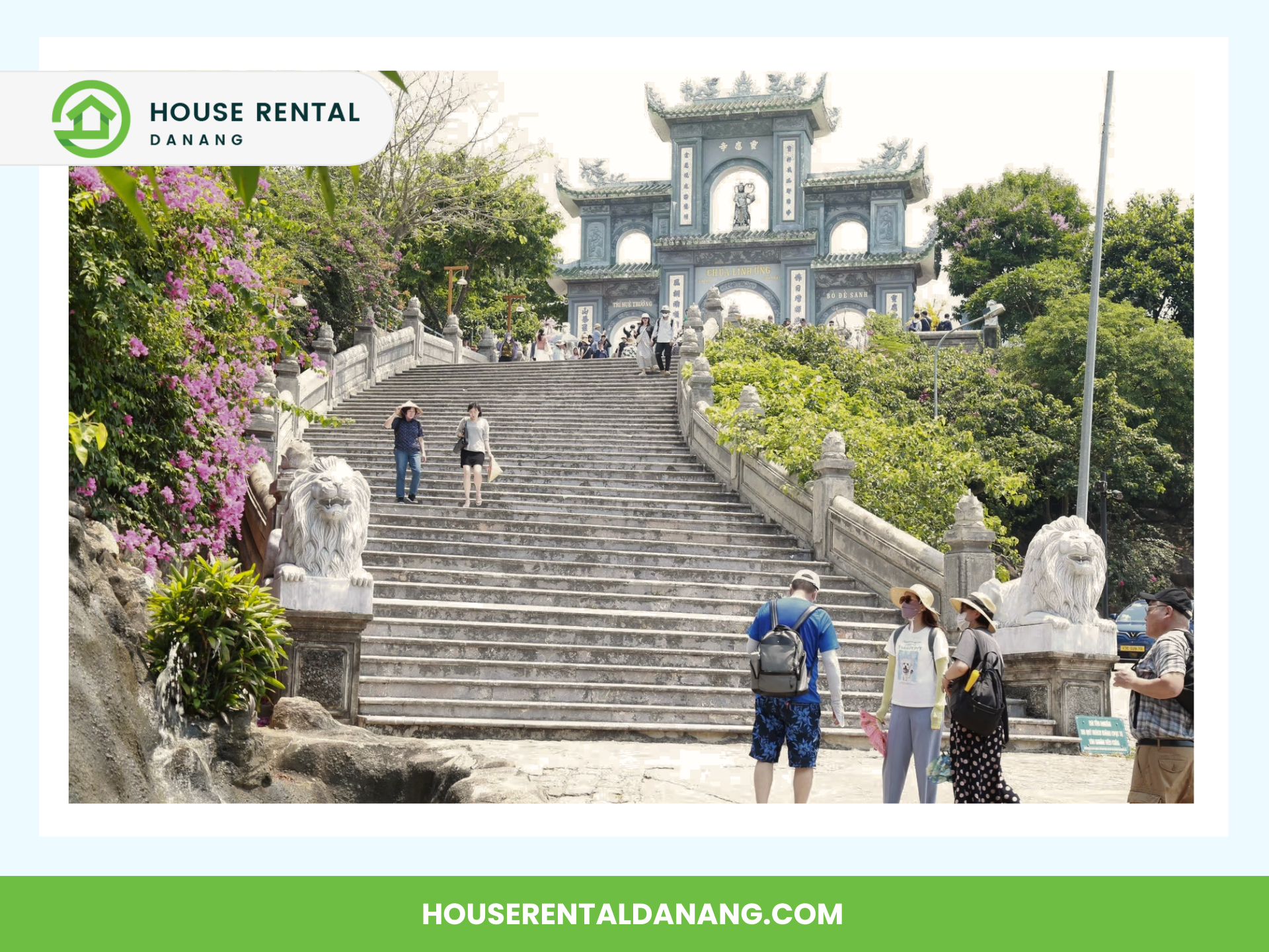 A stone staircase leading to a traditional archway at Linh Ung Pagoda, with tourists walking and taking photos. The area is surrounded by greenery and has statues of lions on either side of the stairs.