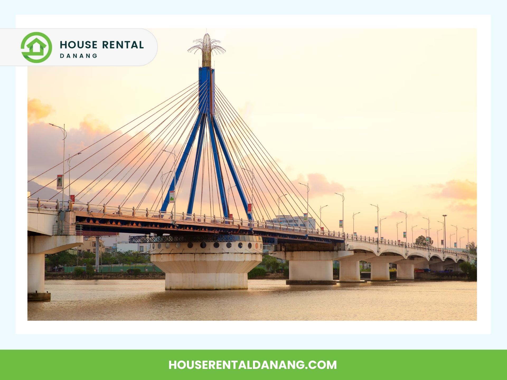 A suspension bridge spans a calm river at sunset, connecting two land areas with visible light posts along its structure. The Han River Bridge is beautifully illuminated. The image is framed with a logo and website address for House Rental Danang.