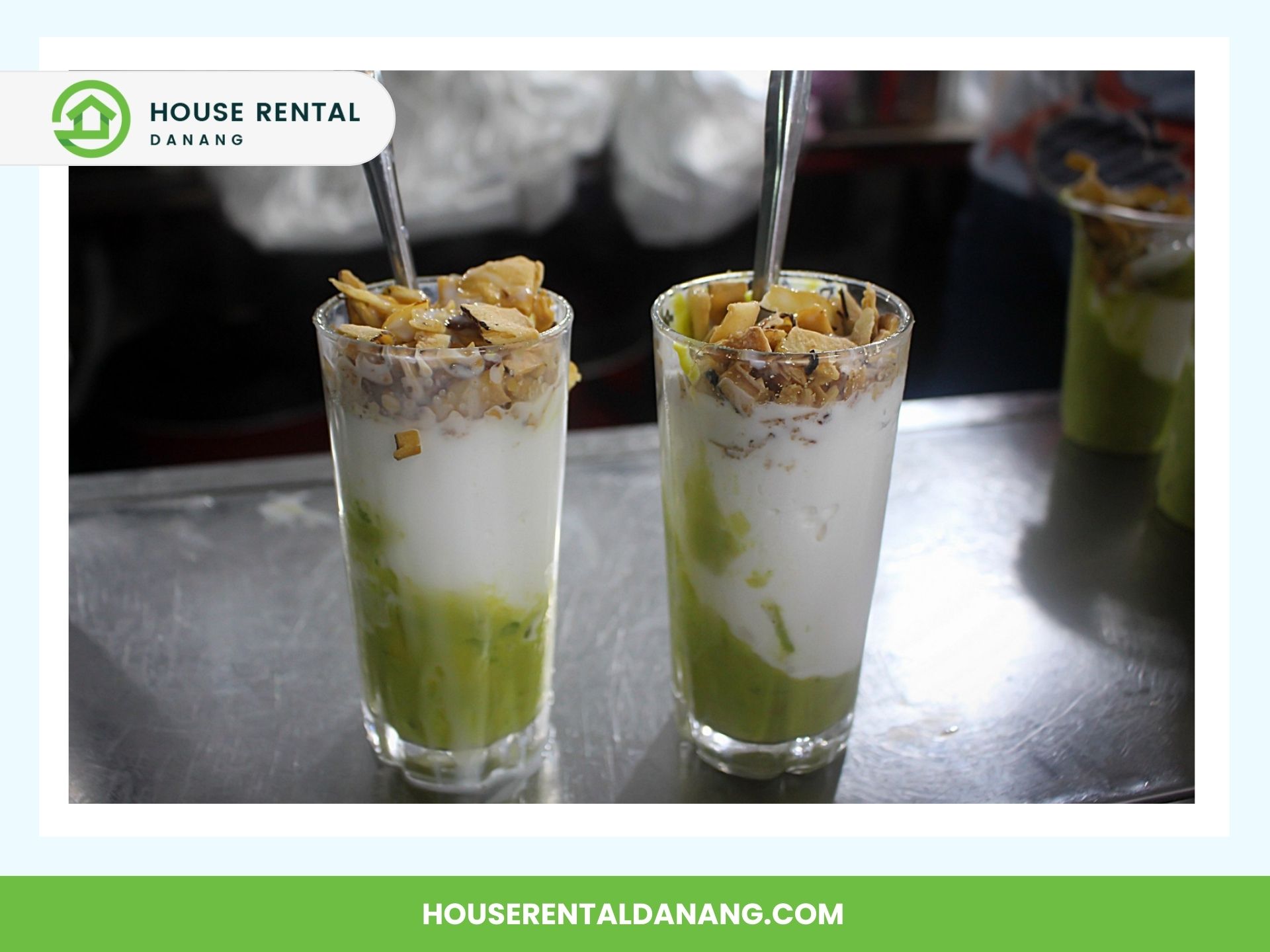 Two glasses of a layered dessert with green, white, and brown components, topped with crushed nuts, sit enticingly on a table at the con market, each accompanied by a metal spoon.