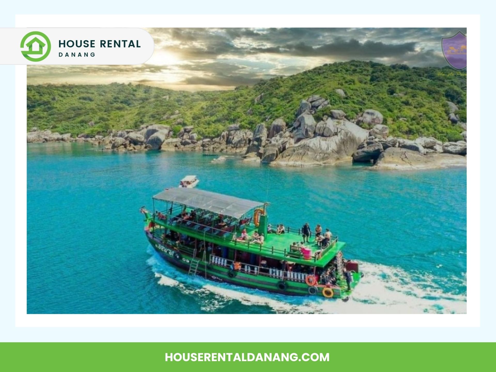 A green and blue boat sails on clear blue water near a rocky, tree-covered coastline, capturing the essence of Cham Island's natural beauty. The image features the branding of "House Rental Danang" and their website URL at the bottom, highlighting an inviting tourism experience.