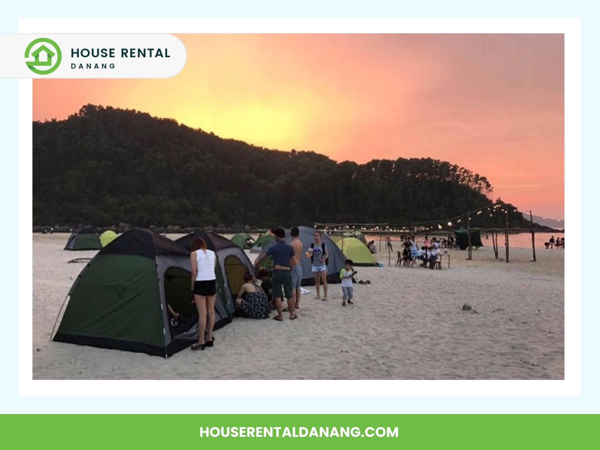 People are setting up tents on a sandy beach at sunset near the scenic Hai Van Pass. A group is gathered around a dining area, and there are trees and a hill in the background. Text reads "House Rental Danang" and "houserentaldanang.com.”