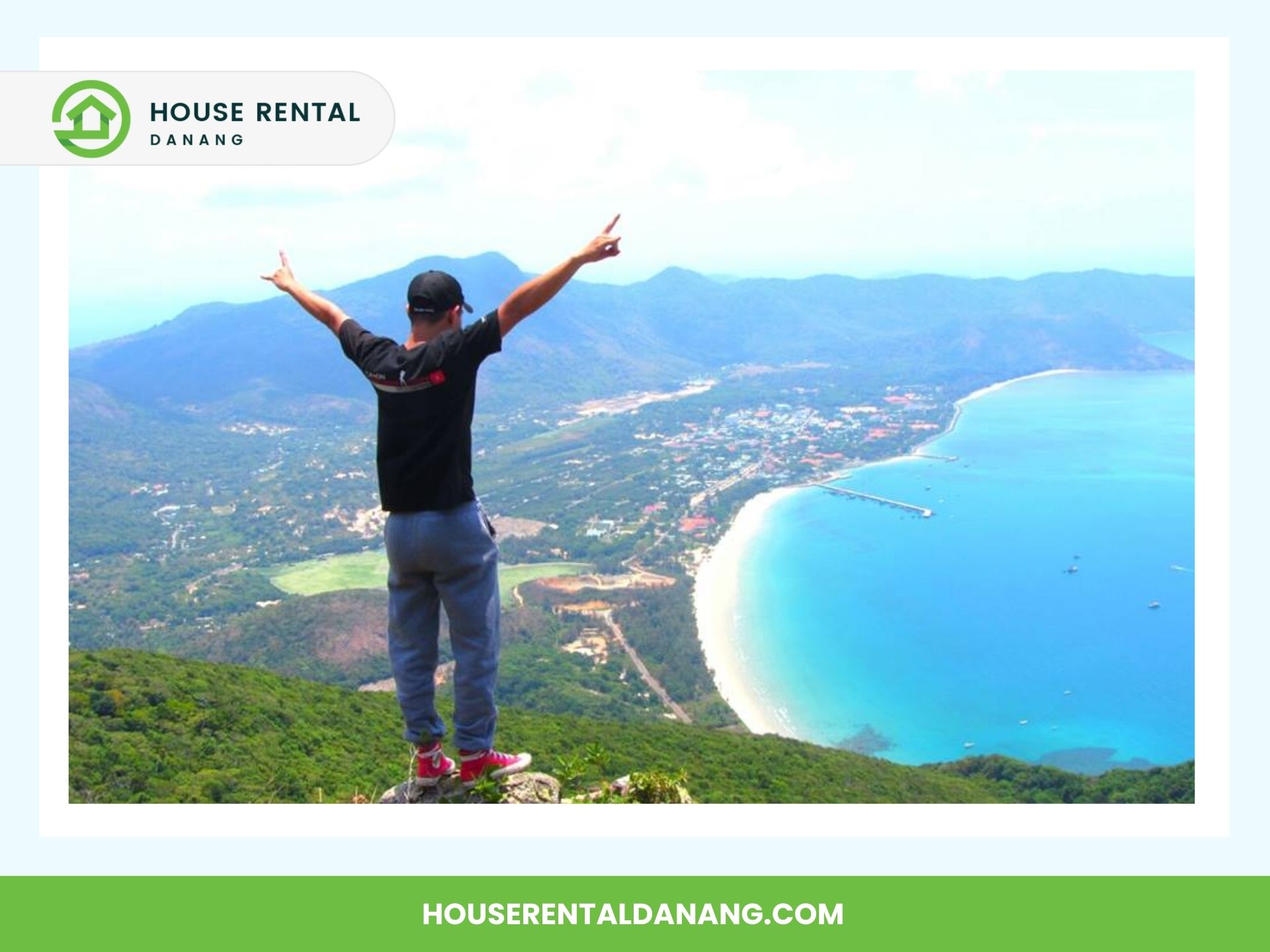 Person standing on Ban Co Peak with arms raised, overlooking a coastal town and a beach with turquoise waters. Text on image: "House Rental Danang" and "houserentaldanang.com".