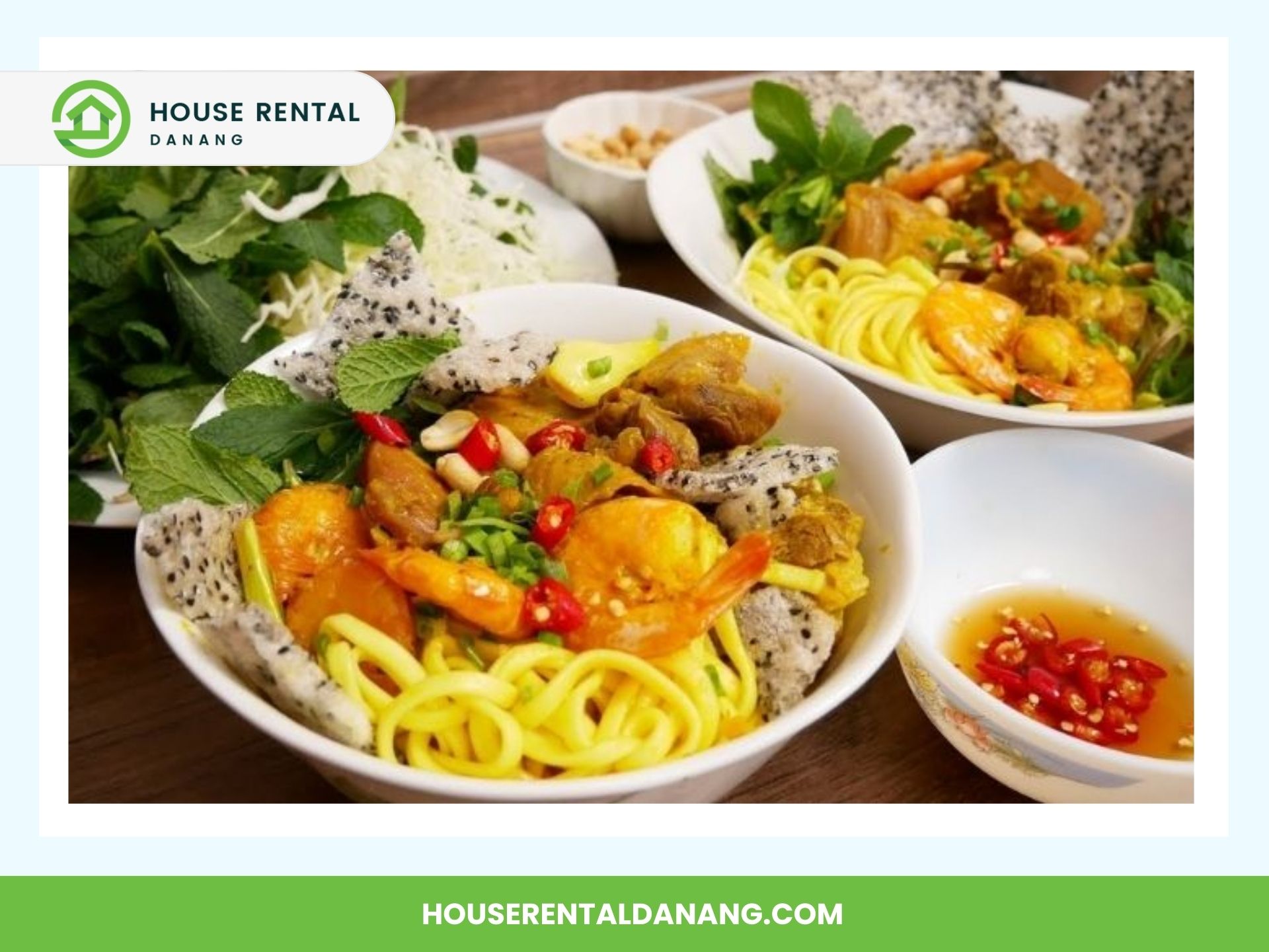 Two bowls of Vietnamese noodle soup topped with shrimp, herbs, and peanuts, accompanied by fresh greens and a bowl of dipping sauce with chopped red chilies, reminiscent of a bustling day at Con Market.