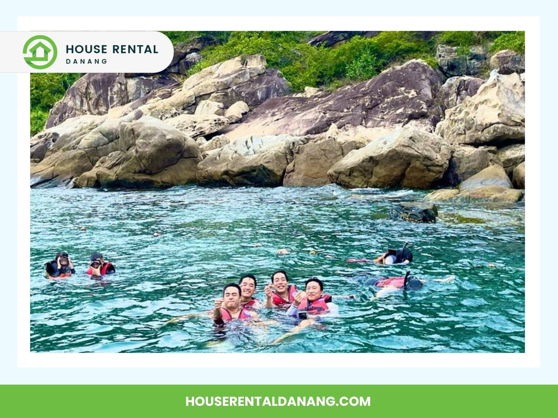 A group of people in life jackets are swimming in the sea near large rocks at Cham Island. The image is branded with "House Rental Danang," showcasing one of the top travel reasons to visit this stunning destination.