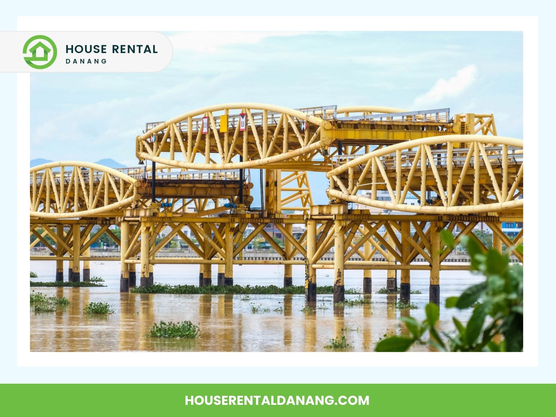 Yellow steel bridge structure over a body of water, likely the Han River, with the logo for House Rental Danang and the URL houserentaldanang.com in the image corners.