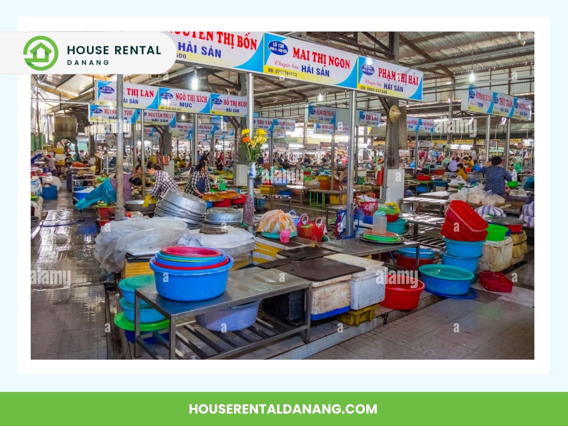 Con Market is an indoor market with multiple vendor stalls selling various goods, including plastic containers and seafood. Each stall has signage in Vietnamese, and the floor is wet.